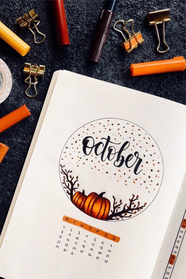 bullet journal spread with fall pumpkin