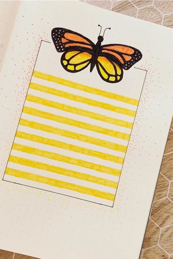 bullet journal page with yellow butterfly doodle