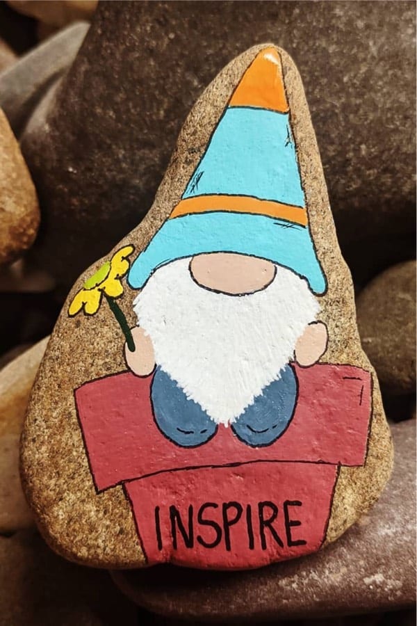 painted pebble with garden gnome design