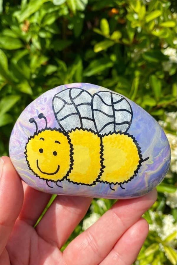 kids painted stone with bee