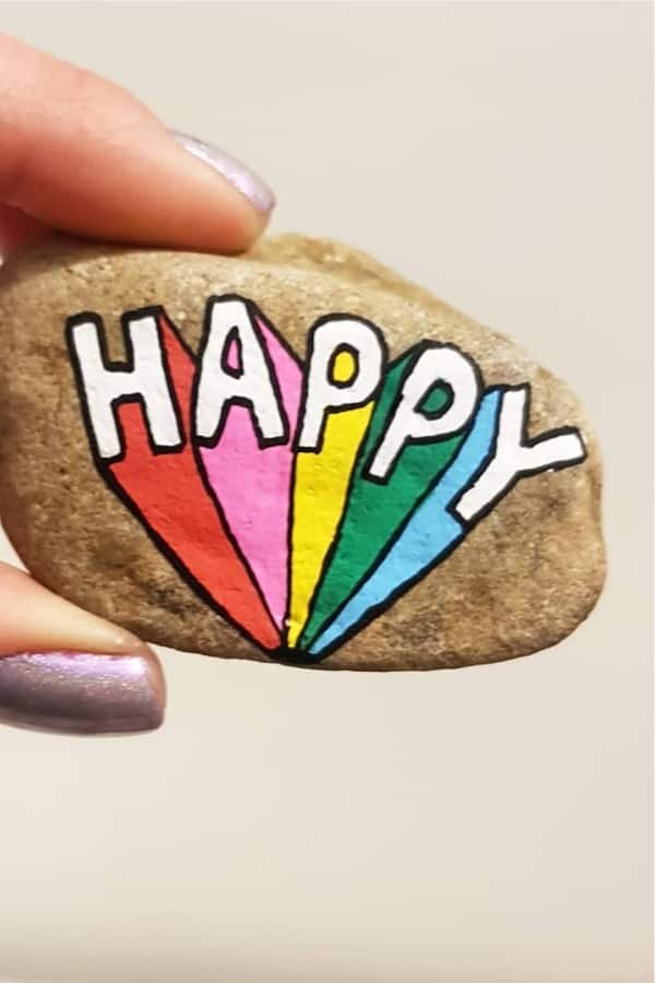 painted rock design with happy quote