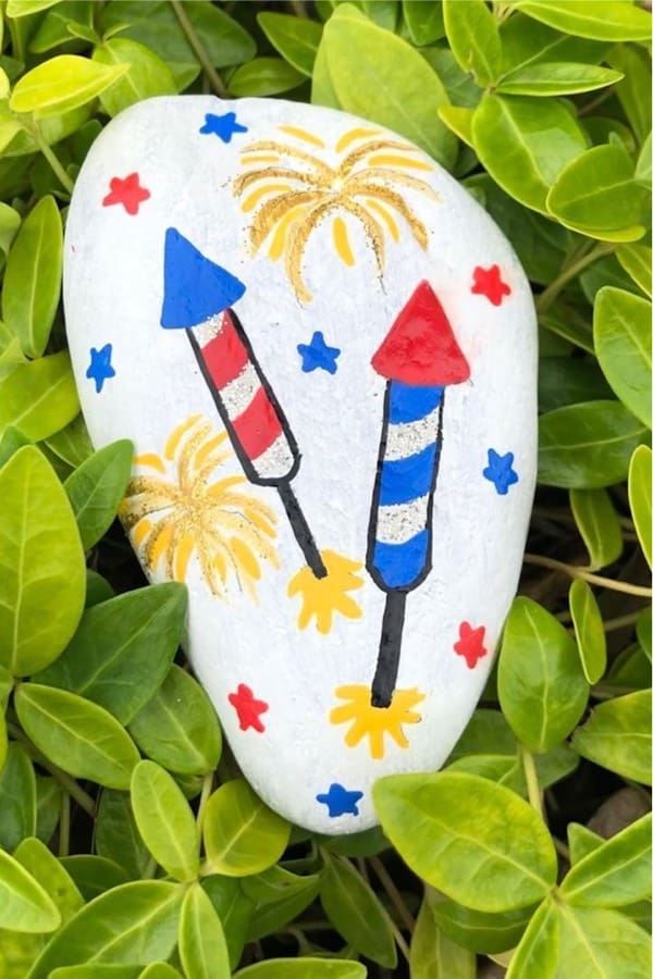 white painted rock with fireworks