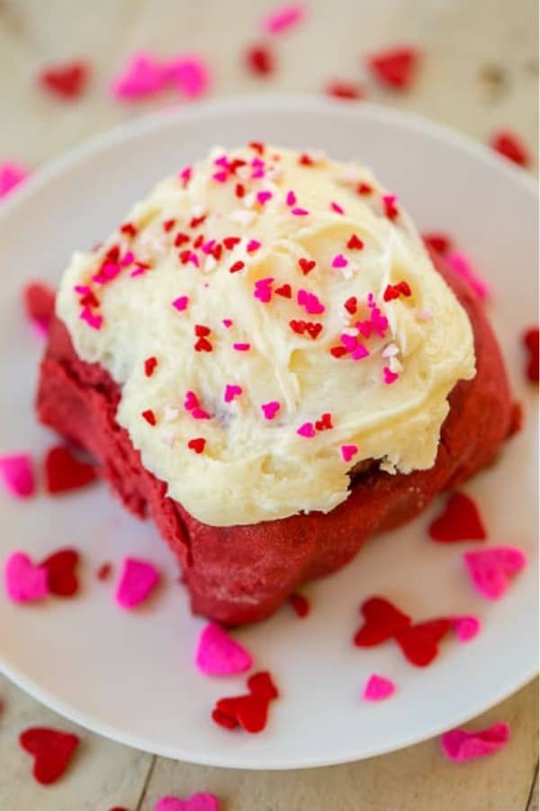 red cinnamon rolls with heart sprinkles