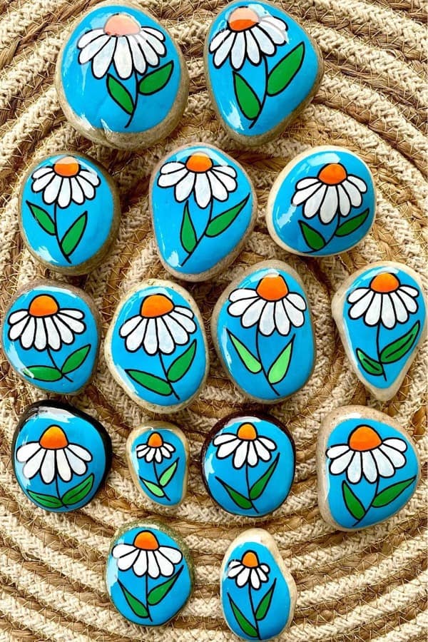 small painted stones with daisy decoartion