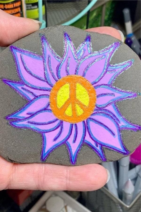 flat stone painted with purple flower