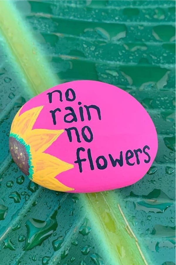 pink kindness rock with yellow sunflower design