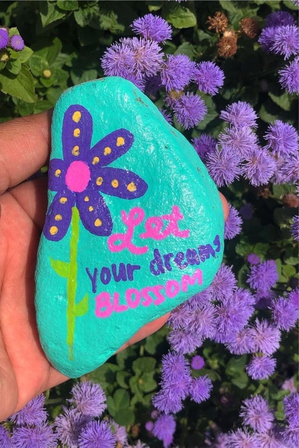 pebble painting idea with purple flower