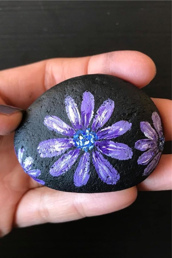 black rock with purple flower painting