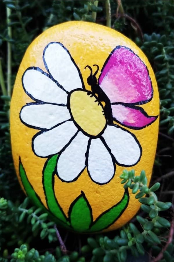 painted stone examples with flower designs