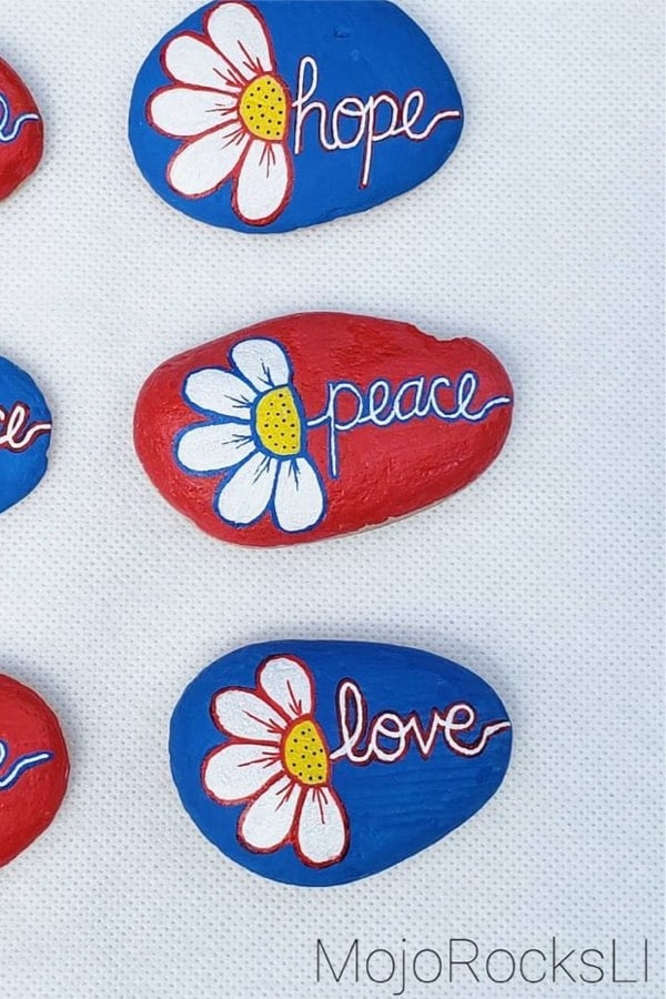 hand painted pebbles with white flower