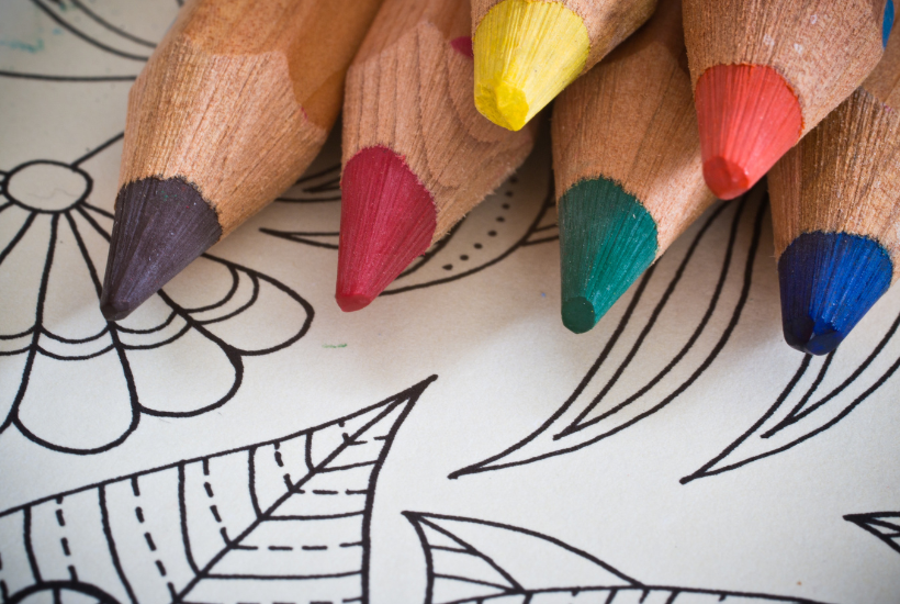 Colorful Pencils on A Coloring Book