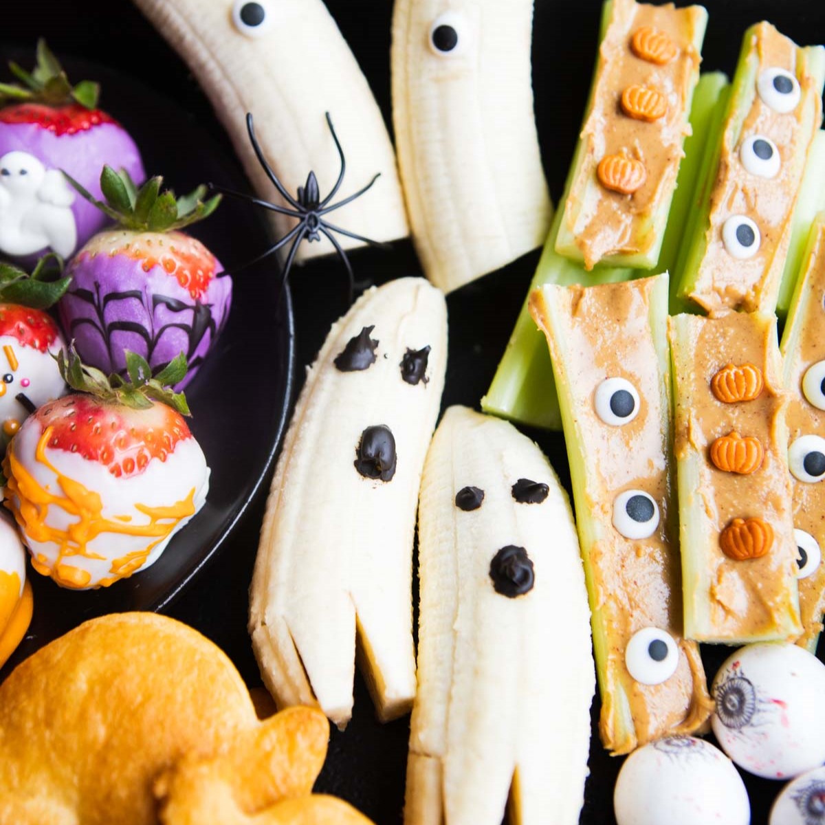 Banana halves with chocolate chip eyes and mouths standing as ghosts