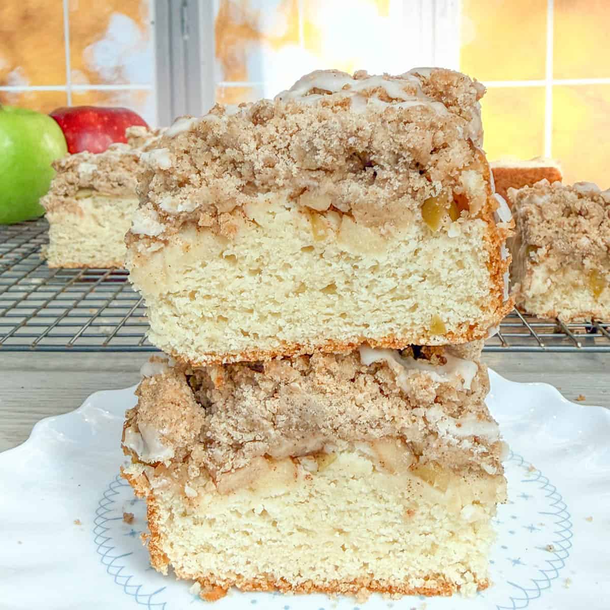 Stacked slices of cinnamon-streusel apple cake with cider glaze