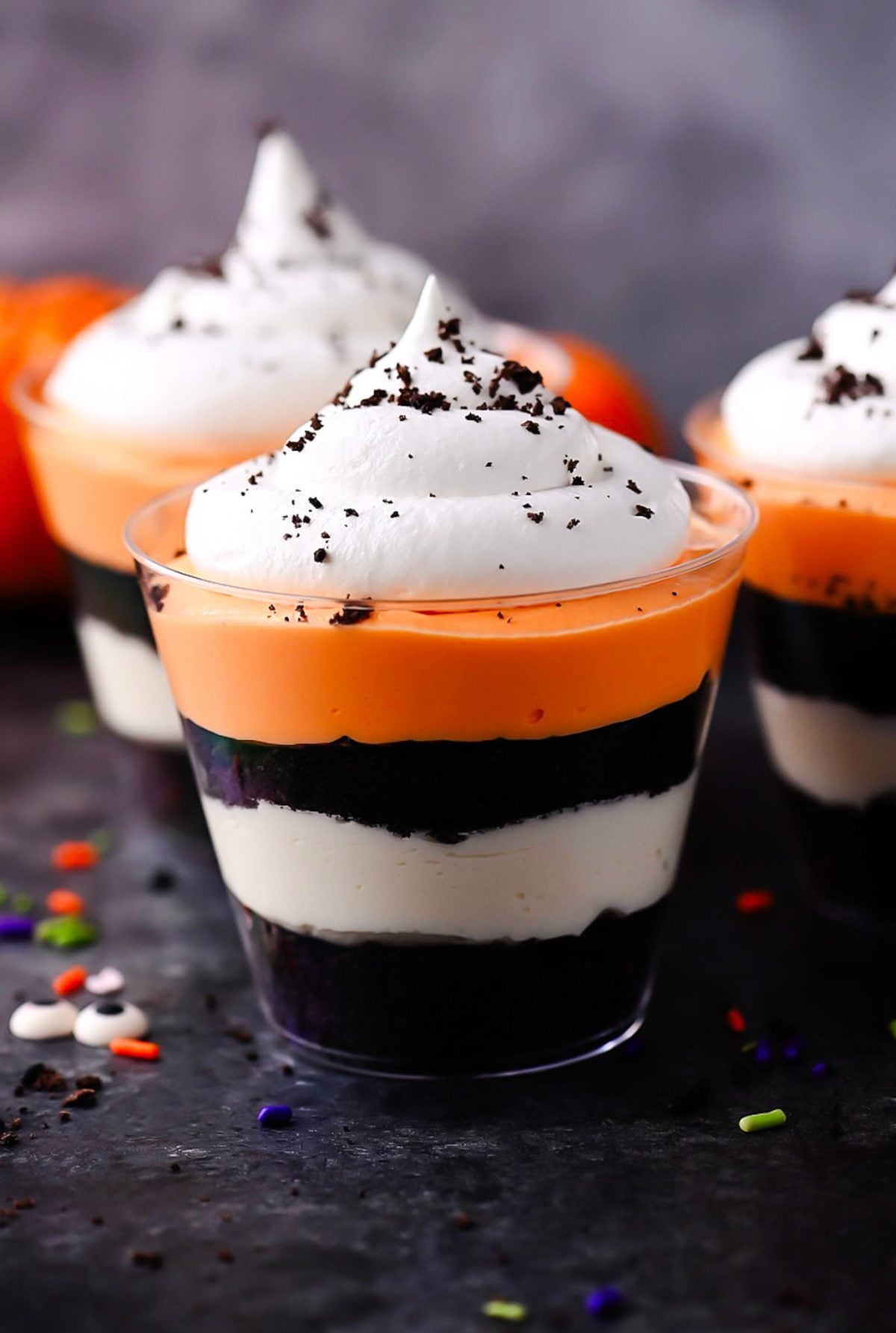 No-bake Halloween cheesecake cups layered in individual glasses
