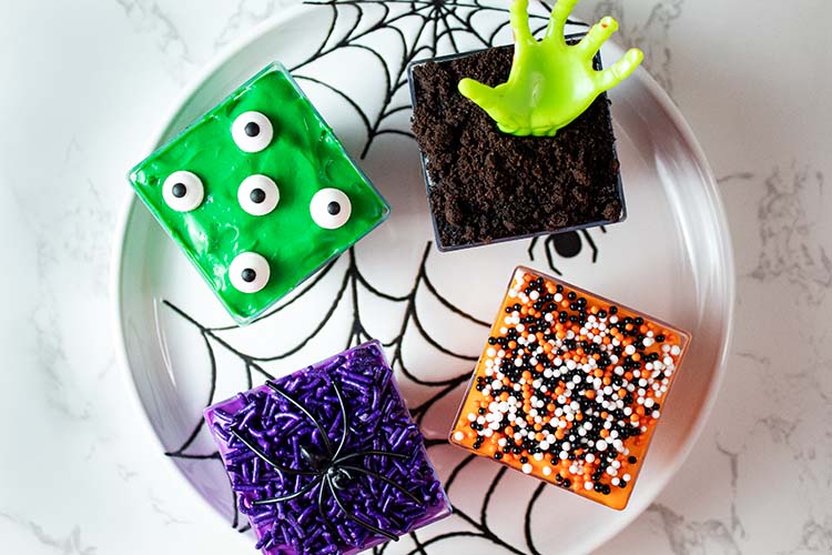 Colorful Halloween cheesecake cups with candy eyes and sprinkles