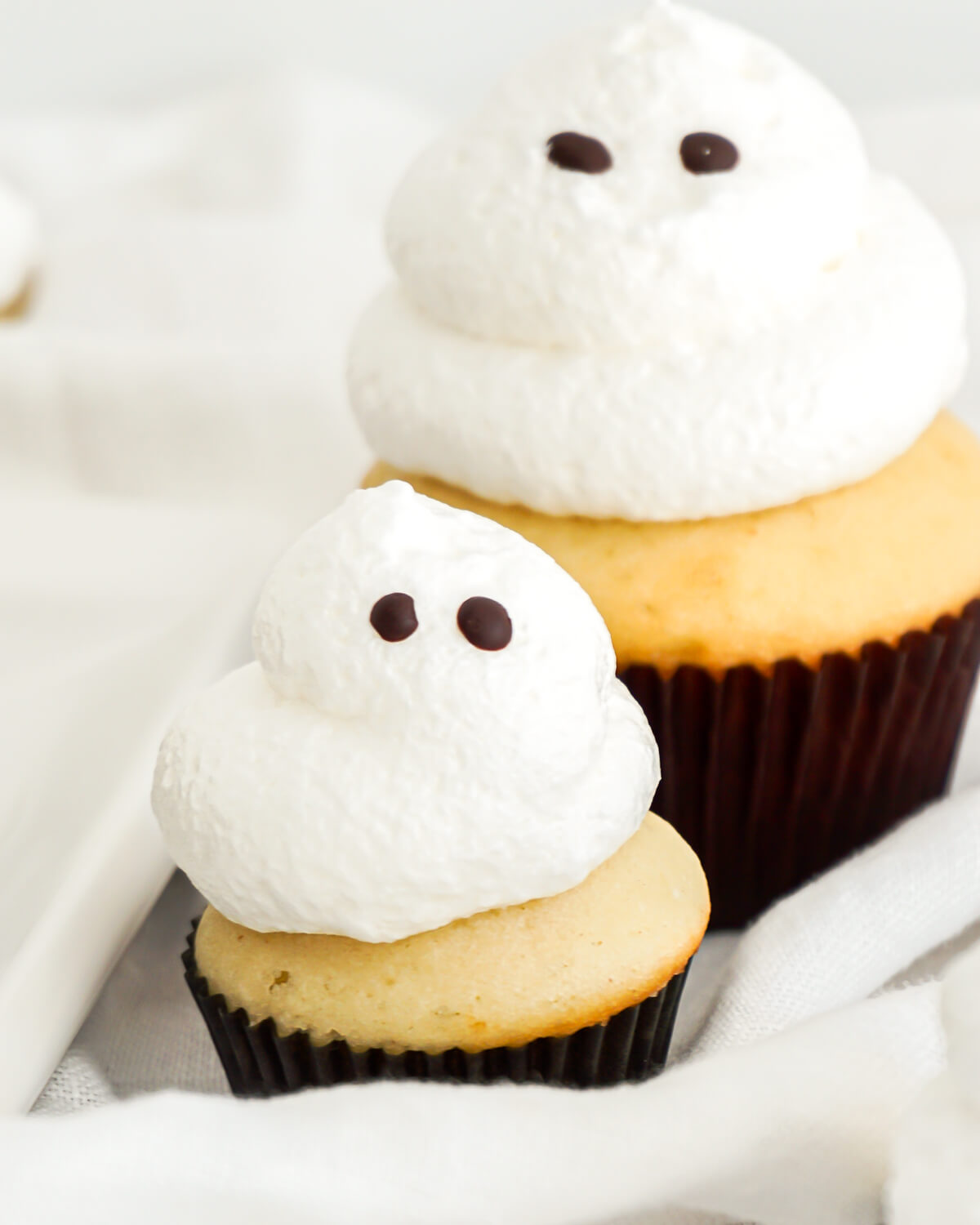 Ghost cupcakes with soft meringue ghosts on vanilla cupcakes
