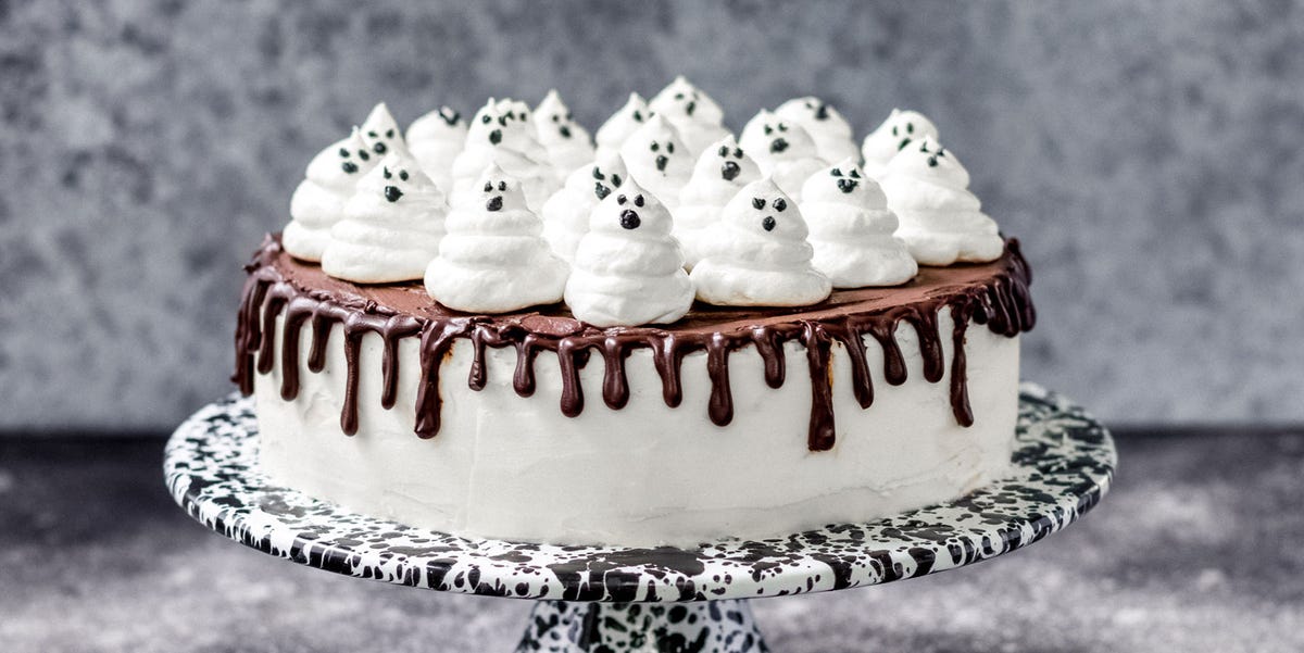 Ghost cake with chocolate drip and meringue ghosts on top