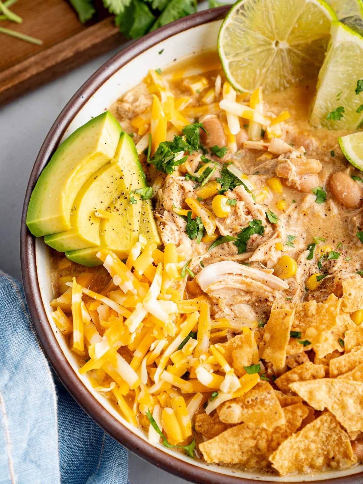 Creamy white chicken chili in a bowl with toppings