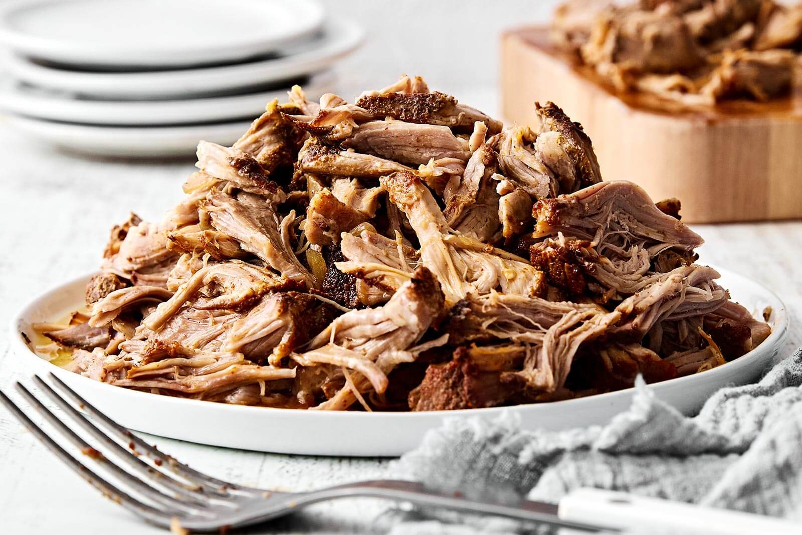 Pile of tender slow cooker pulled pork ready for sandwiches